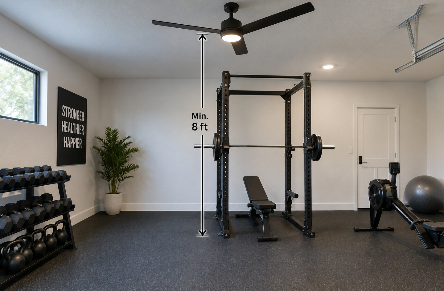A black power rack and bench in a home gym with a ceiling fan mounted close to the rack bay and a vertical marker running from the floor up to the fan.