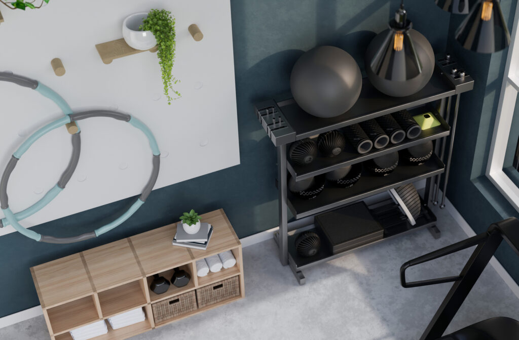 Small home gym storage ideas seen from above: an open shelf rack of medicine balls and foam rollers, a low wooden cube shelf and a wall pegboard holding hoops.